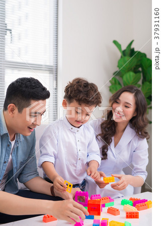 Happy family. Young mother and father playing Happy family. Young mother and father playing 37931160