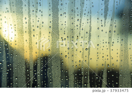 Rain on the glass at sunset Rain on the glass at sunset 37933475