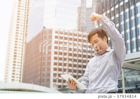 investor young businessman standing using a laptop investor young businessman standing using a laptop 37934814