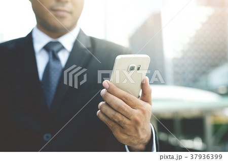 close up of businessman using telephone smart phon 37936399