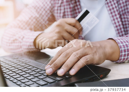 Hands holding credit card Hands holding credit card 37937734