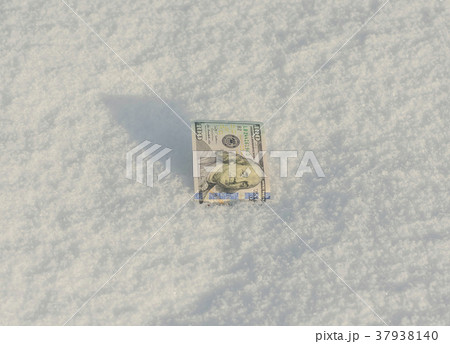 Banknote of a hundred US dollars in the snowdrift  37938140