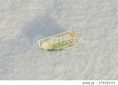 Banknote of a hundred US dollars in the snowdrift  37938143