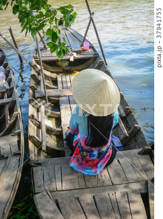 Woman in traditional dress on wooden boat 37941755