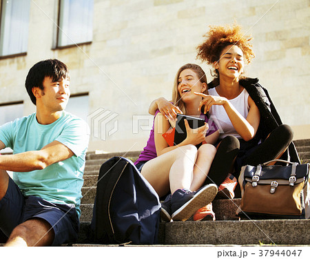 cute group of teenages at the building of 37944047