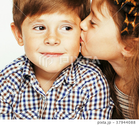 little cute boy and girl hugging playing on white little cute boy and girl hugging playing on white 37944088