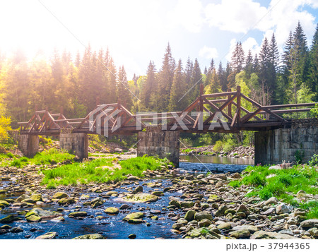 Wooden Soumarsky bridge over Vydra mountain river Wooden Soumarsky bridge over Vydra mountain river 37944365