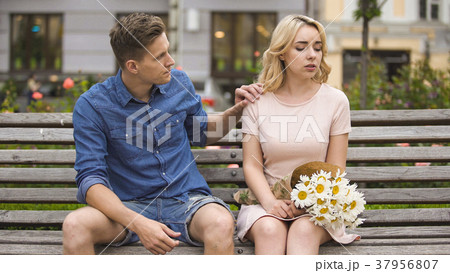 Young man feeling guilty, touching offended Young man feeling guilty, touching offended 37956807