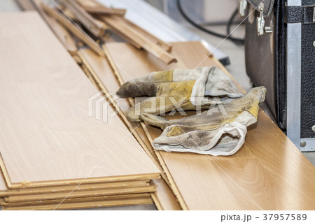 Pair of used gloves lying on removed laminate 37957589