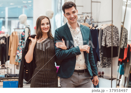 Woman and man shopping clothes in fashion store 37958497