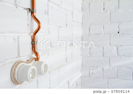 A vintage outlet and electrical wiring in a copper 37959114
