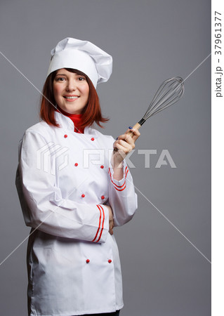 Photo of female chef in white robe and cap with 37961377
