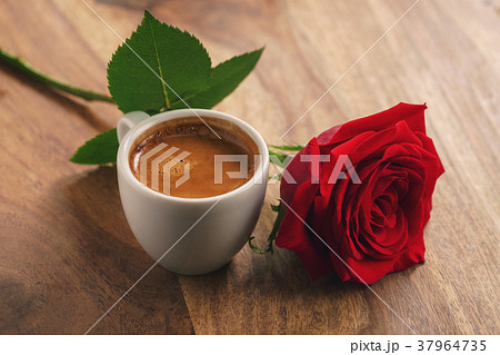 fresh espresso with red rose flower on wood table fresh espresso with red rose flower on wood table 37964735