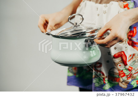Housewife cooking with saucepan Housewife cooking with saucepan 37967432