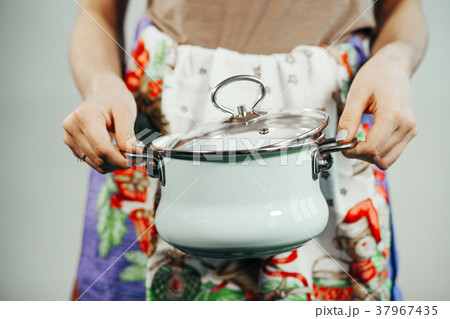 Housewife cooking with saucepan Housewife cooking with saucepan 37967435