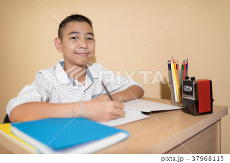 Little boy use pencil writing on notebook homework Little boy use pencil writing on notebook homework 37968115