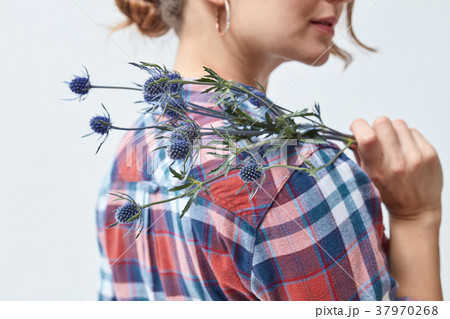 Young girl with flowers eryngium Young girl with flowers eryngium 37970268