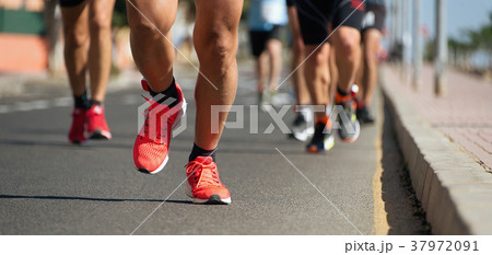 Marathon running in the light of evening 37972091