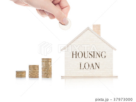 Wooden house model with coins next to it and hand 37973000