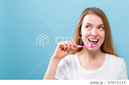 Young woman holding a toothbrush Young woman holding a toothbrush 37973115