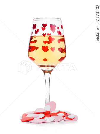 Glass of white wine with red and pink heart shape 37973202