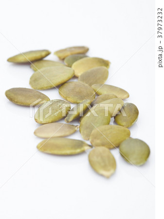 Healthy organic pumpkin seeds on white Healthy organic pumpkin seeds on white 37973232