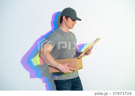 Serious postman looking at package Serious postman looking at package 37973728