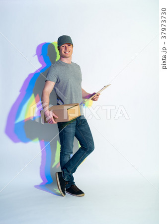 Beaming man holding package in hands 37973730