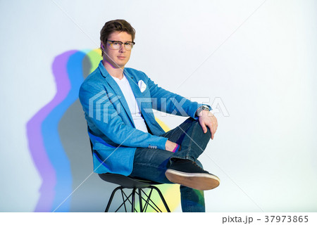 Serious businessman sitting on chair 37973865