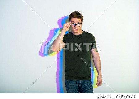 Smart young man demonstrating amazement Smart young man demonstrating amazement 37973871