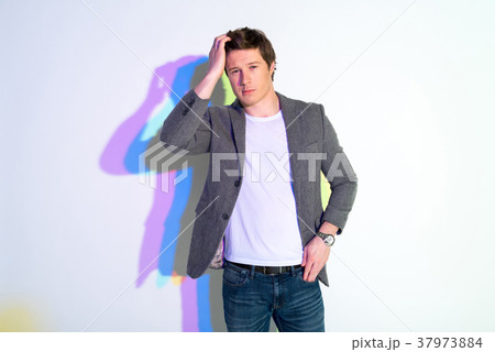 Assured man looking forward and posing Assured man looking forward and posing 37973884