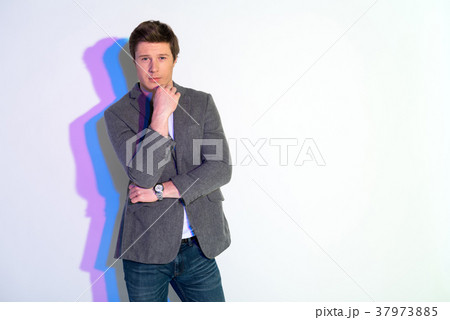 Serene male touching chin by arm Serene male touching chin by arm 37973885