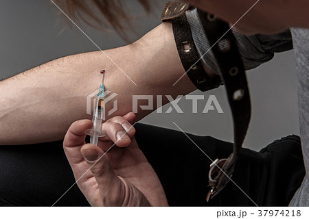 Junkie male doing narcotic injection 37974218