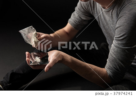 Man arms emptying coke from packaging Man arms emptying coke from packaging 37974241