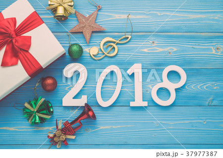 White new year or Christmas gift box with red ribbon for holiday concept on blue wooden. Top view with empty space for text and design 37977387