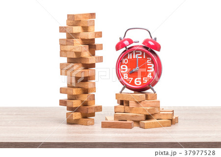 Pile of blocks wood game and red alarm clock on wooden table. Studio shot and isolated on white 37977528