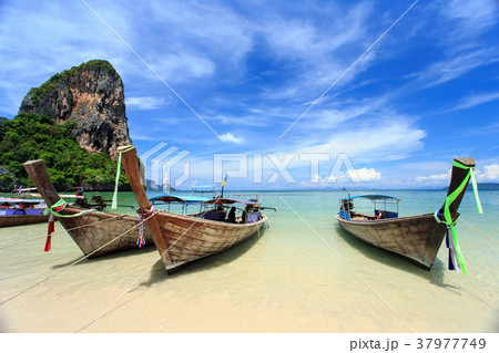 Traditional Thai boat, Long tail stand in the sea at Railay beach, Krabi, Thailand Traditional Thai boat, Long tail stand in the sea at Railay beach, Krabi, Thailand 37977749