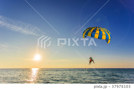 Tourist is para sailing over the blue sea in Thailand 37978103