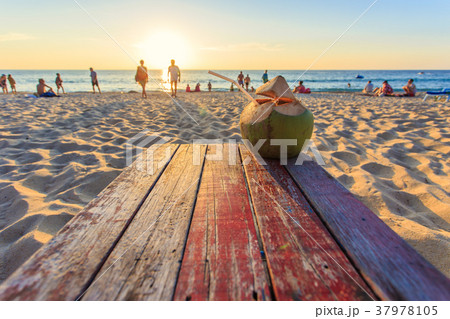 Coconut on the table at sunset beach in Thailand 37978105