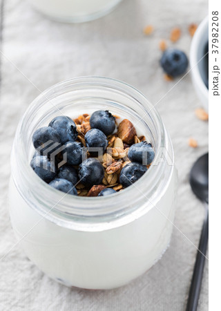Yogurt with fresh blueberries and granola in a jar Yogurt with fresh blueberries and granola in a jar 37982208