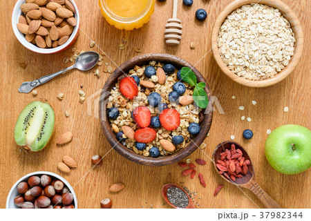 Healthy breakfast food on wooden table. Granola 37982344