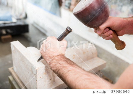 Stonemason working at marble pillar Stonemason working at marble pillar 37986646