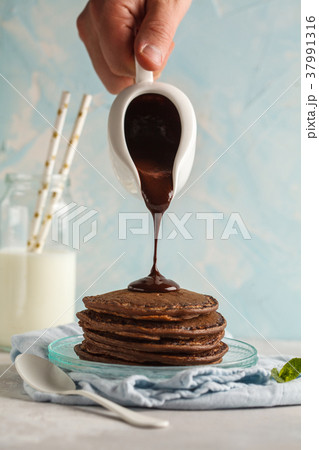 Chocolate pancakes with chocolate syrup Chocolate pancakes with chocolate syrup 37991316