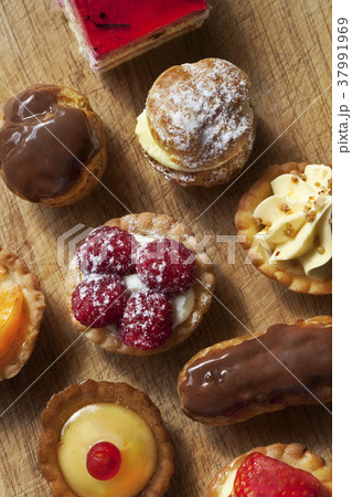 Various cakes on a board 37991969