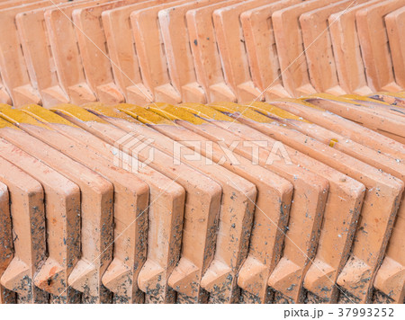 Closeup of the orange tiles stack. 37993252