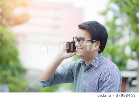 Handsome Business man in an using telephone glad 37993455