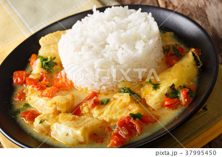 Stew fish with sauce of cilantro, onions, tomato 37995450