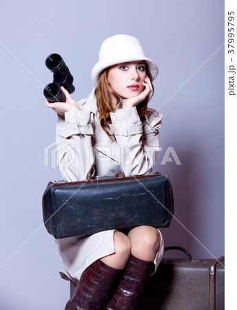 young redhead girl with suitcase and binocular young redhead girl with suitcase and binocular 37995795