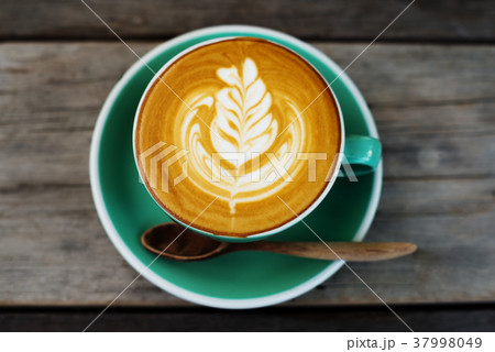 Cappuccino coffee in a green cup Cappuccino coffee in a green cup 37998049
