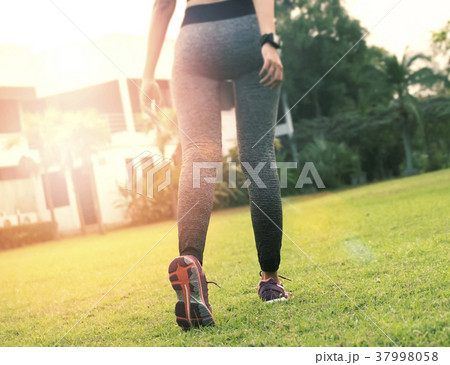 young runner women jogging at road with sunset  37998058